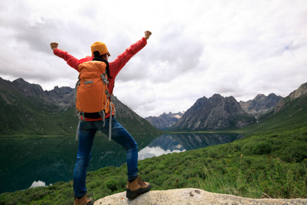istock cheering young backpacking woman hiking in mountains 855336734