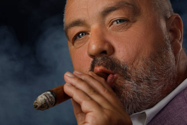 istock Bearded attitude man holding cuban cigar  Smoking  Individuality portrait 855337628