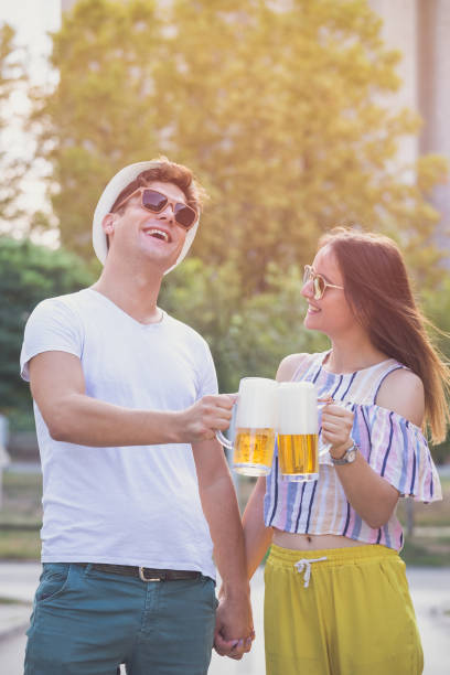 istock Couple toasting with beer outdoor 855342276