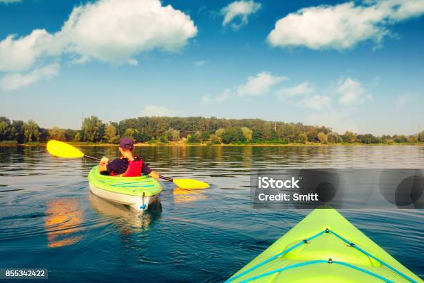 Boy In Life Jacket On Green Kayak Stock Photo - Download Image Now - Kayaking, Kayak, Lake