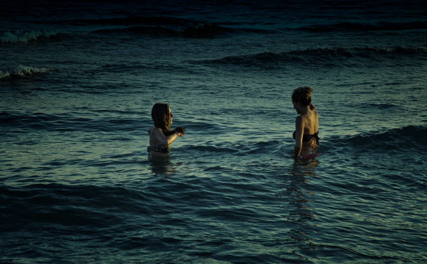 istock Women at night in the sea 855342578