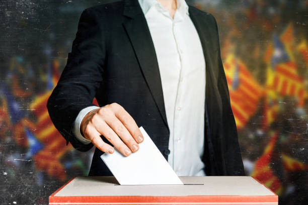 istock Man Voter Putting A Ballot Into A Voting box. Democracy Freedom Concept 855342648