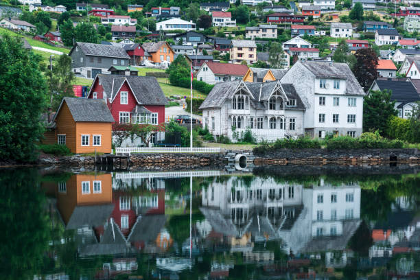 Cloudy summer view of Hardangerfjord and Norheimsund village, Norway, Europe