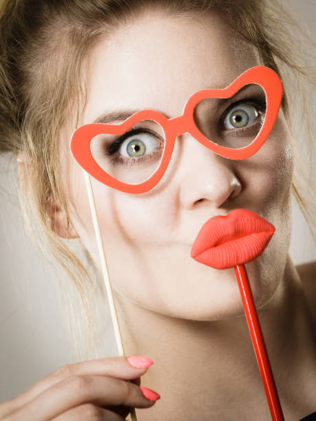 istock woman holds carnival accessories on stick 855349496