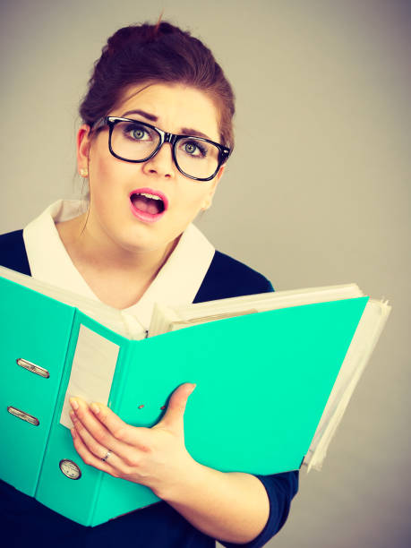 istock Shocked business woman looking at documents 855349594