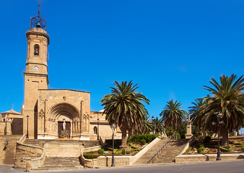 a view of the facade of the Colegiata de Santa Maria la Mayor in Caspe, Spain