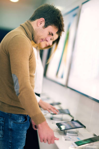 istock Couple choosing a new digital tablet in a shop 855353760