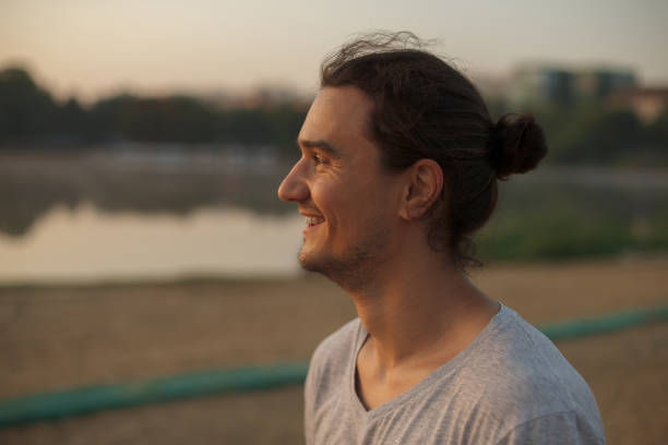 istock Handsome man smiling in the park 855355102