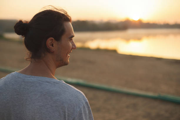 istock Handsome man smiling in the park 855356654