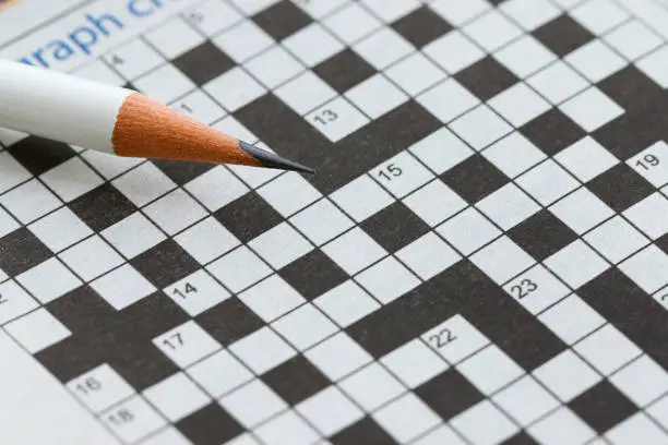 Photo of Crossword Puzzle and Pencil