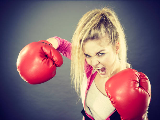 istock Angry woman wearing boxing gloves 855359428