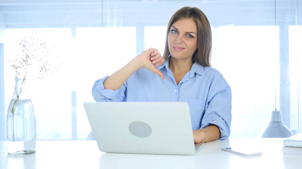 istock Thumbs Down, Frustrated Woman Gesture while Sitting in Office 855359936