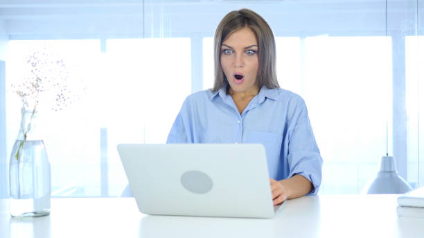 istock Young Woman Gesturing Shock at Work, Astonished 855360032