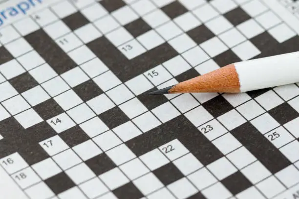 Photo of Crossword Puzzle and Pencil