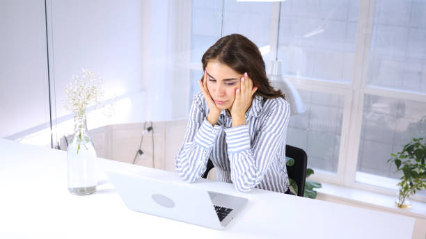 istock Sad Woman Sitting at Work, Reading on Laptop 855360500