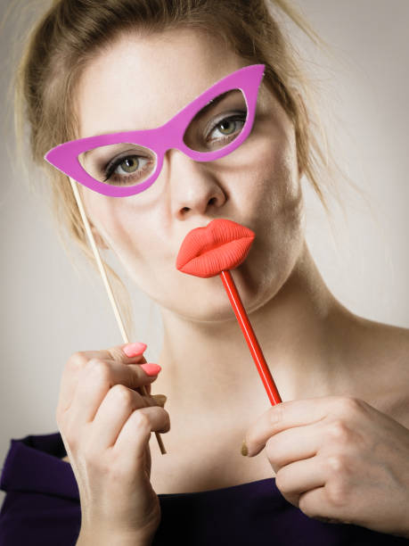 istock woman holds carnival accessories on stick 855363522