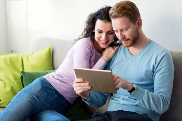 istock Young couple using digital tablet at home 855368386