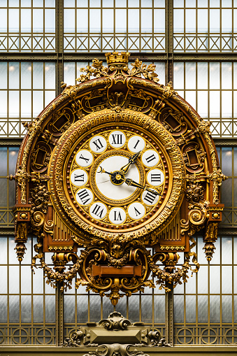 Paris, France - July 05, 2017: Golden clock in the Orsay Museum. The Musee d'Orsay is a museum in Paris, on the left bank of the river Seine. Musee d'Orsay has the largest collection of impressionist and post-impressionist paintings in the world.