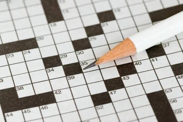 Photo of Crossword Puzzle and Pencil