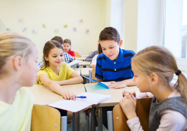 istock group of school kids writing test in classroom 855372542