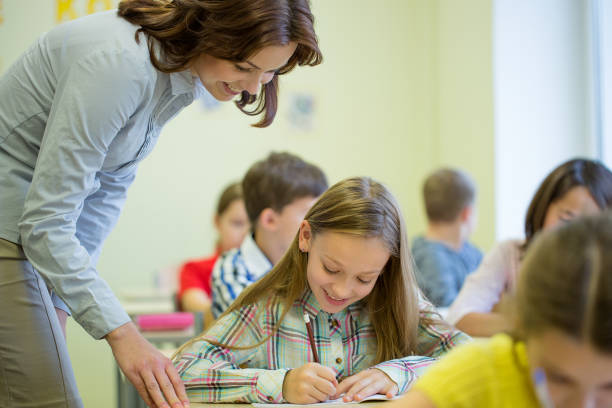 istock group of school kids writing test in classroom 855375514