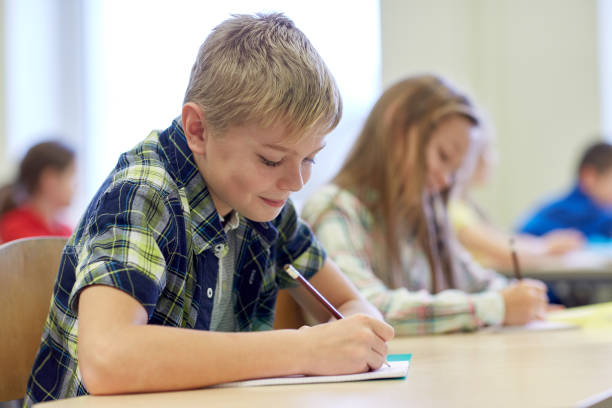 istock group of school kids writing test in classroom 855375758