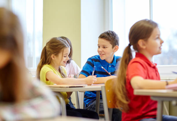 istock group of school kids writing test in classroom 855375918