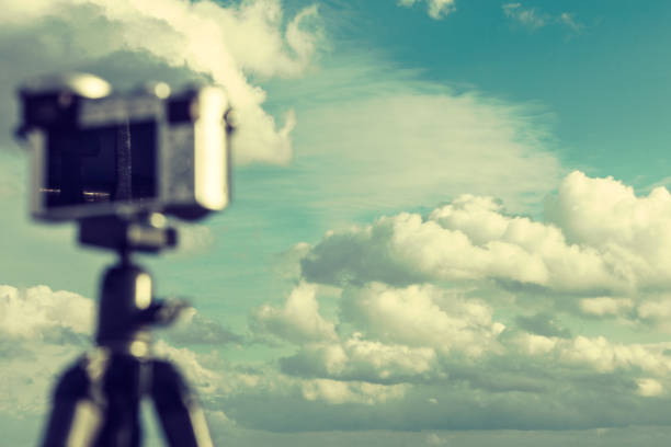 Photography objects and equipment. Photo camera on small tripod taking picture of nature.