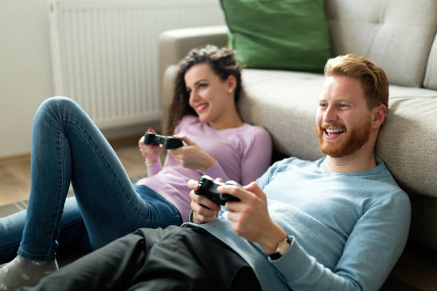 istock Happy couple playing video games at home 855379610