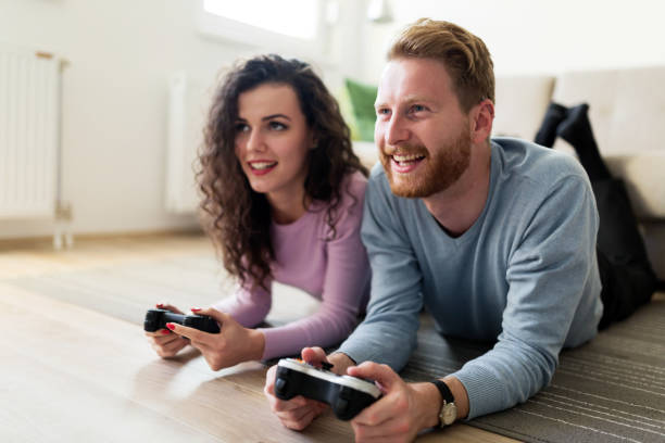 istock Happy couple playing video games at home 855379768