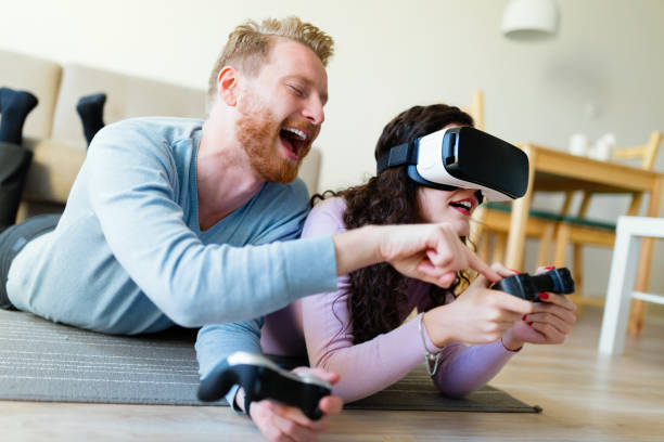 istock Happy young couple playing video games with virtual reality headsets 855382016