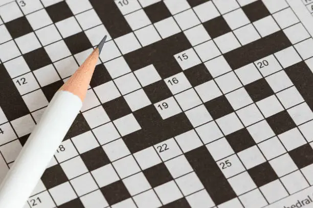 Photo of Crossword Puzzle and Pencil