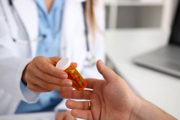 istock Female medicine doctor write prescription at worktable while 855382864