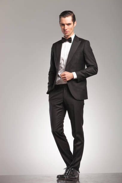 istock elegant business man in tuxedo standing with open coat 855386202