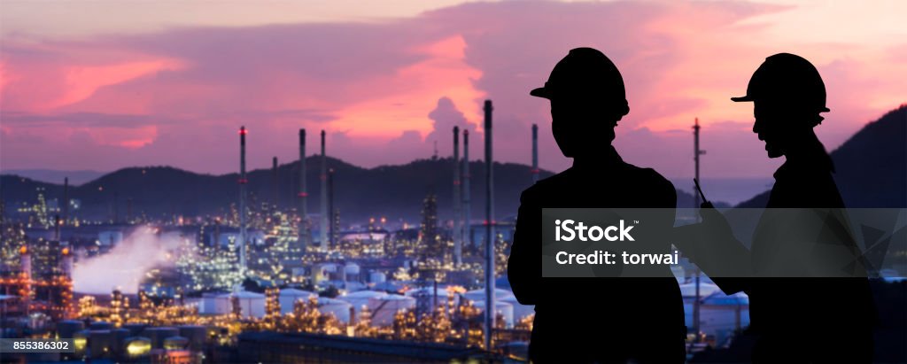 Silhouette engineers are standing orders The oil refining industry Industry Stock Photo