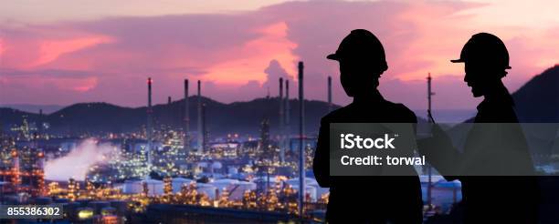 Silhouette Engineers Are Standing Orders The Oil Refining Industry Stock Photo - Download Image Now