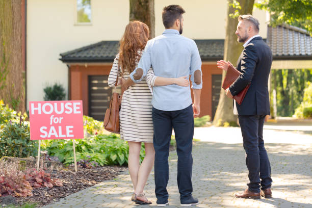 istock Real estate broker and clients 855389964