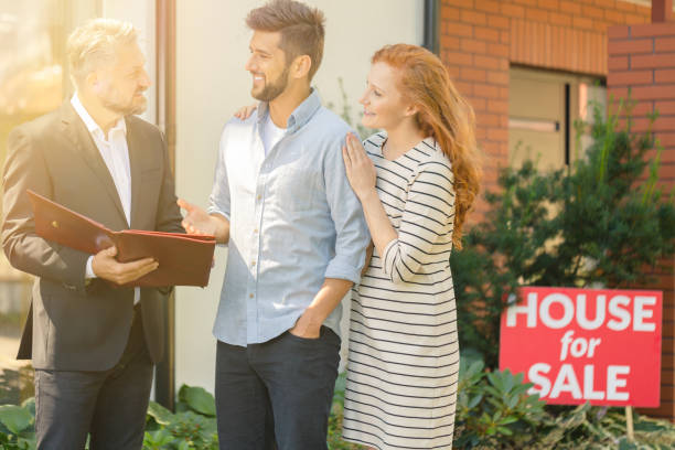 istock Young couple negotiating with agent 855389982