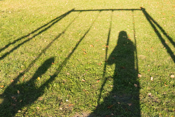 istock Bright swing on the Playground in the Park. The deep shade. An empty swing. 855390924
