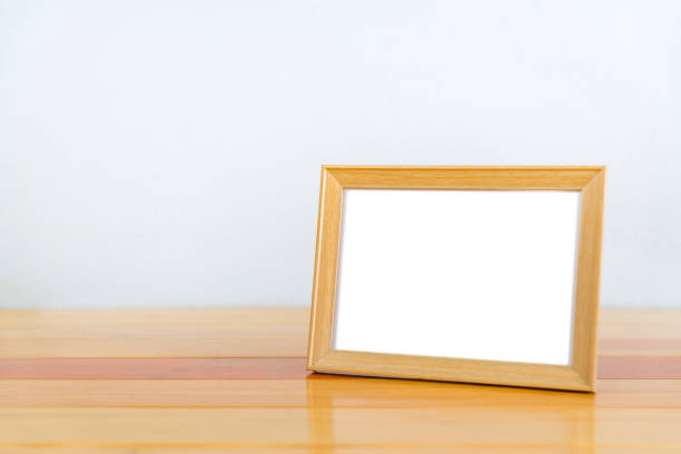 istock Empty wood photo frame on wooden table with copy space, picture memory. 855391080