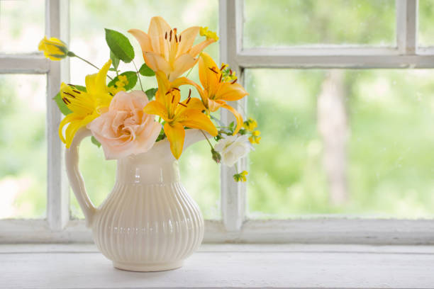 istock flowers in vase on windowsill 855393592