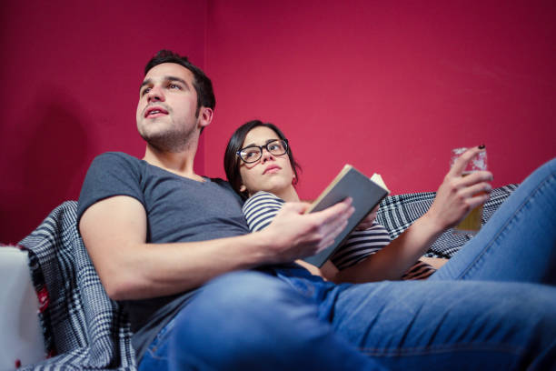 istock Young Couple Got Interrupted In Reading 855393824