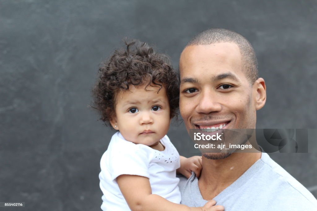 Happy black father and cute little daughter Happy black father and cute little daughter embracing, smiling. Baby - Human Age Stock Photo