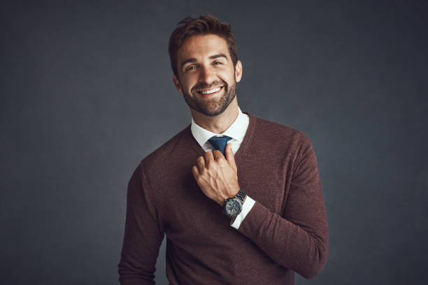 Confidence - a must have for any outfit Studio portrait of a stylishly dressed young man posing against a gray background business casual fashion stock pictures, royalty-free photos & images
