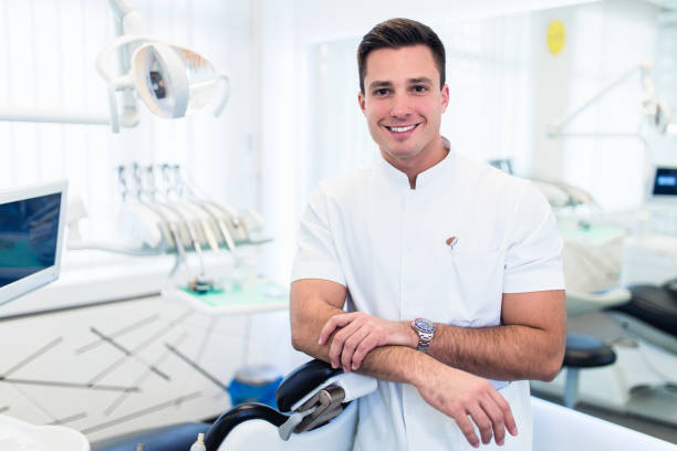 Handsome dentist in his office stock photo