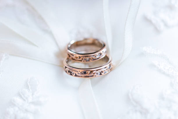 istock Wedding rings on white wedding dress 855405270