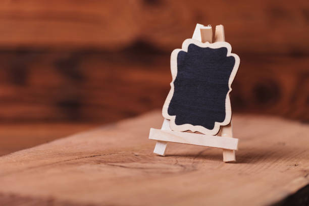 istock little blank black board on old wood background 855408980
