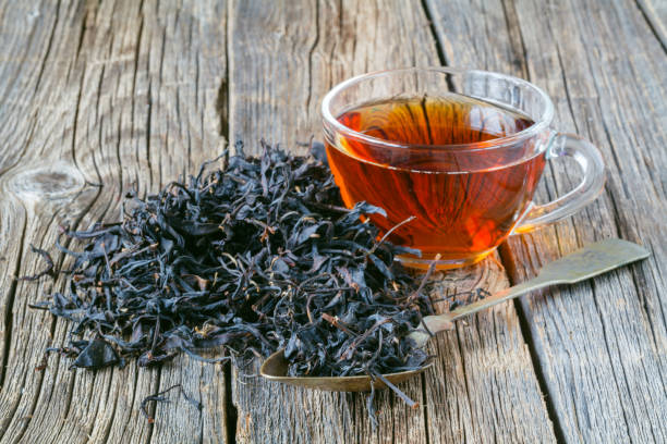 istock Dry leaf of chenesse tea and glass cup 855416720