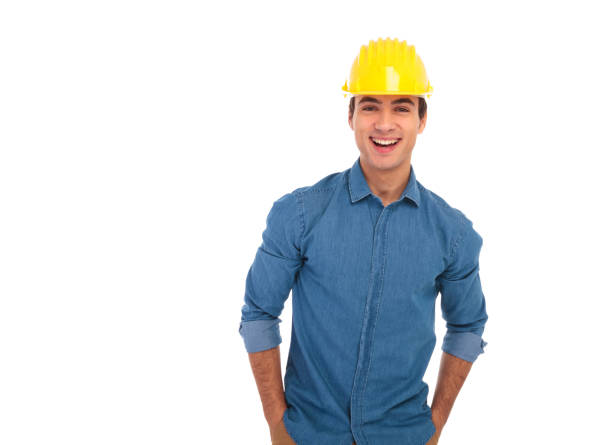 relaxed construction engineer with hands in pockets laughing relaxed construction engineer with hands in pockets laughing for the camera on white background man laughing hard stock pictures, royalty-free photos & images