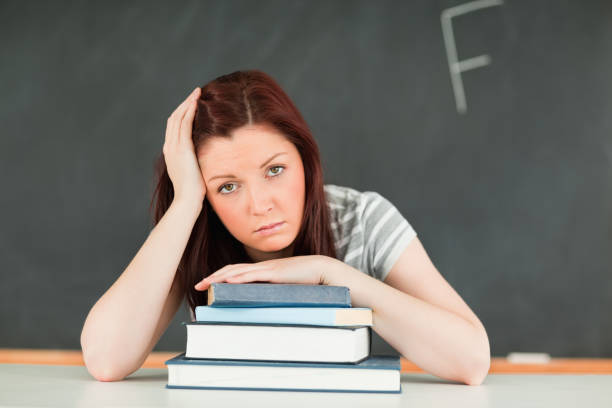istock Sad young student receiving bad mark 855418154